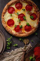 Homemade salami pizza with cheese corners