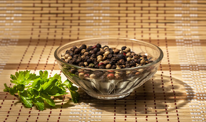 Black pepper peas in a plate and parsley on the table