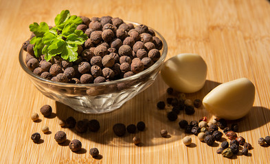 Black pepper peas in a plate, garlic and parsley on the table.