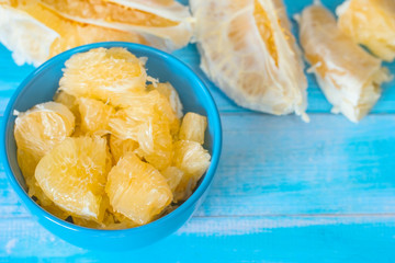 peeled into slices of pomelo in a bowl close-up. pomelo slices close-up. 