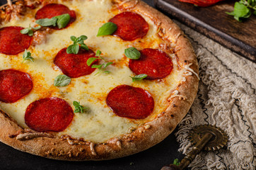 Homemade salami pizza with cheese corners