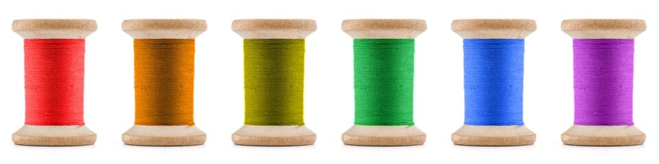 Colorful Spool sewing threads on white background