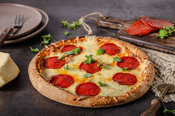 Homemade salami pizza with cheese corners