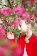 Girl in a blooming garden. Blooming cherry. Sakura.