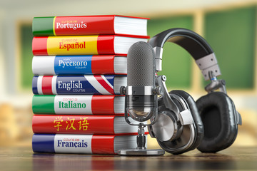 Learning languages online.  Dictionary books of different languages with headphones and microphone. © Maksym Yemelyanov