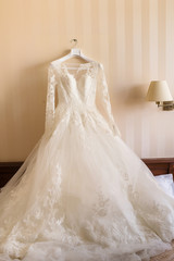 Fototapeta na wymiar Wedding dress in empty room. Bridal morning