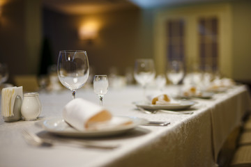 Row of place settings on table for a wedding reception.