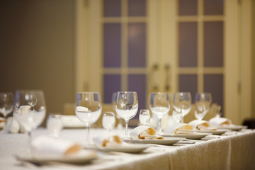Row of place settings on table for a wedding reception.