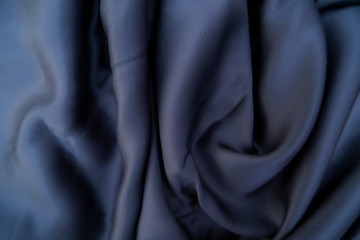 Blue color fabric. Dark blue silk fabric background. Tencel blue sheet.