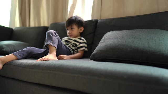 Baby boy sit and relax on the sofa at home