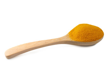 Yellow turmeric powder in a wooden spoon isolated on white background