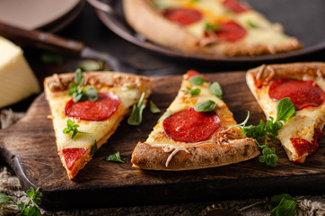 Homemade salami pizza with cheese corners