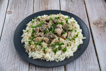 Chicken with mushrooms and rice with greens with cream sauce