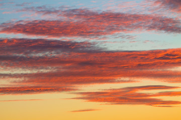 abstract shapes of red,orange sunset clouds like painted abstract pattern can be used as background