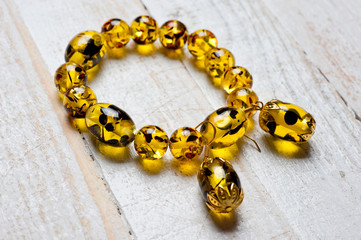 Bright yellow faux amber bracelet and earrings. Background for jewelry and women's jewelry.