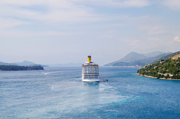 Gigantic huge modern Italian Costa Cruises cruiseship or cruise ship liner departs port of...
