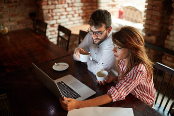 Man and woman having leisure time together in cafe