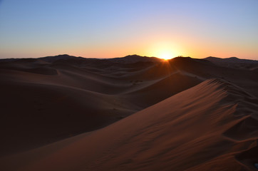 Fototapeta na wymiar Sand Dunes in the Hot Dessert of Morocco