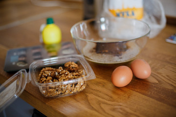 
The ingredients for making muffins lie on a wooden tabletop. photo with place for text