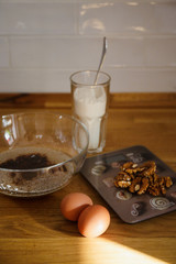 
The ingredients for making muffins lie on a wooden tabletop. photo with place for text