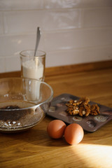 
The ingredients for making muffins lie on a wooden tabletop. photo with place for text