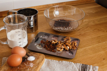 
The ingredients for making muffins lie on a wooden tabletop. photo with place for text