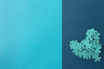 Mint heart from puzzle pieces on blue textured backdrop with copy space for your text and design. Medical series background conceptual image. Template for banner, website or booklet. Top view