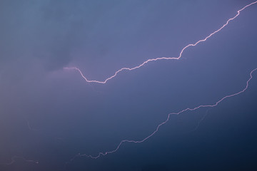 Lightning shoots across a clear evening sky