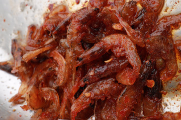 Fried dried chili prawns served on a plate