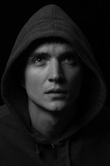 Fototapeta na wymiar Black and white male portrait in low-key light
