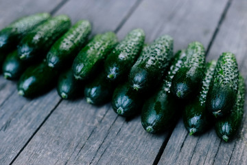 Cucumbers on wooden surface. Seasonal fresh vegetables.