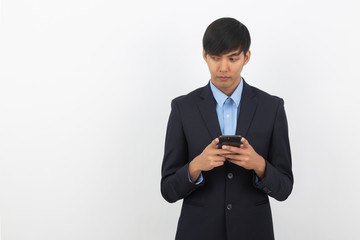 Young asian businessman in black suit using smartphone isolated on white background, Online shopping, Remotely working.