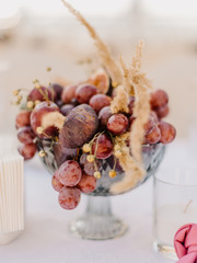 Wedding decor with grape, pear, fig and succulent. Boho style. Fine art photography