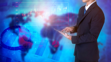 Close up of business man is using tablet  with analytics finance graphic