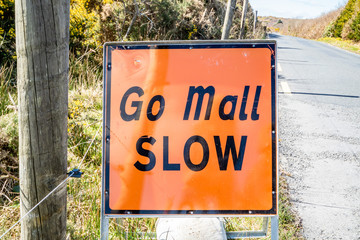 Empty country road in County Donegal during the Coronavirus pandemic with the sign Go Mall - Translation: Slow - Ireland