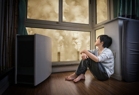 Young Asian Boy Wearing Face Mask At Home To Protect Against Air Pollution