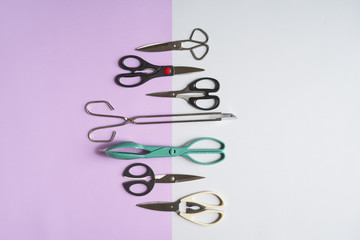 Various Types On Scissors On grey and pink background