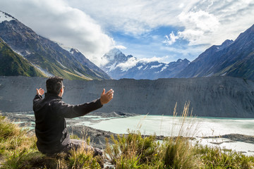 Man with open arms during at Mount Cook, New Zealand ..