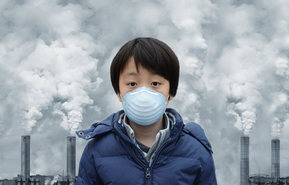Young Asian boy wearing face mask to protect against air pollution ( Beijing - China)