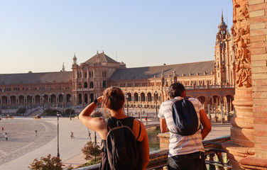 Couple of tourist looks Spain square in a sunny day in summer