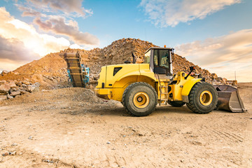 Excavator and stone crusher in a quarry
