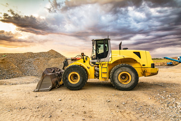 Earthworks with an excavator for the construction of a road