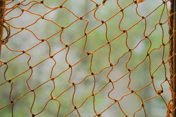Rope netting on blurred natural background.  Copy space. Minimalism.