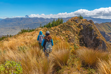 Two women walking along the Quilotoa Loop trekking in the Andes mountains near Quito, Ecuador.