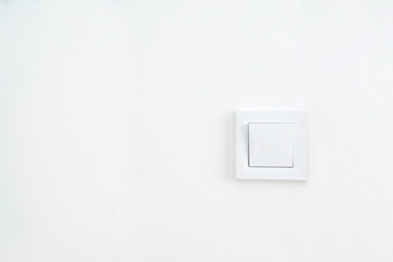 On the wall with a picture there is a power outlet in white