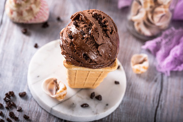 Fototapeta na wymiar Delicious summer dessert chocolate ice cream in waffle cone. Summer healthy food concept, lactose free. High angle view.
