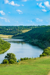 Fototapeta na wymiar Summer landscape. The river and the hills