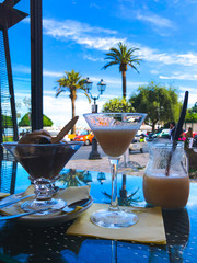 Enjoying cocktails with a view on the promenade and Mediterranean sea in Rapallo on a sunny day,...