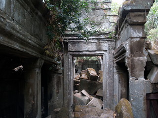 Fototapeta na wymiar Corridor with Piles of Stone Slabs, Beng Mealea Temple, Siem Reap, Cambodia