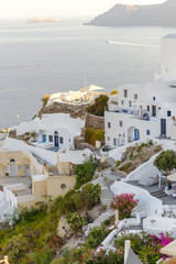 Fototapeta premium Panorama of the city during sunset in the village of Oia, Santorini.